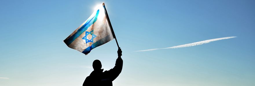 successful silhouette man winner waving Israel flag on top of the mountain peak